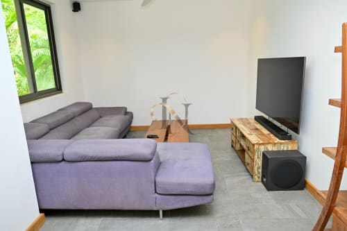 Salon moderne de la villa Nora à Gerards & Angel, Grand Baie, avec sièges violets, TV écran plat et boiseries