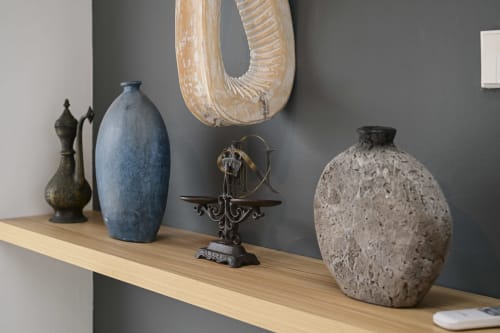 Étagère décorée avec vase bleu, poterie texturée et sculpture en bois à la villa Gerards & Angel à l'Île Maurice