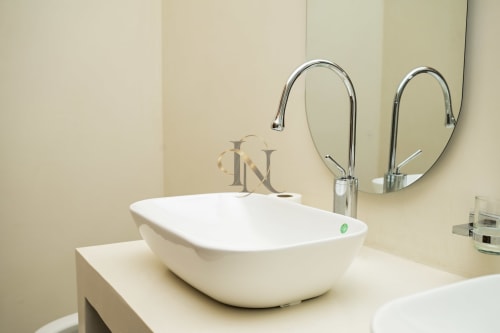 Lavabo vasque blanc moderne avec robinetterie chromée et double miroir dans la salle de bains de la Villa Coin des Zils à Gerards & Angel, Île Maurice