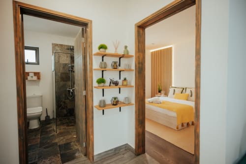 Gerards & Angel villa hallway with bathroom, bedroom, and wooden shelving in Pereybere