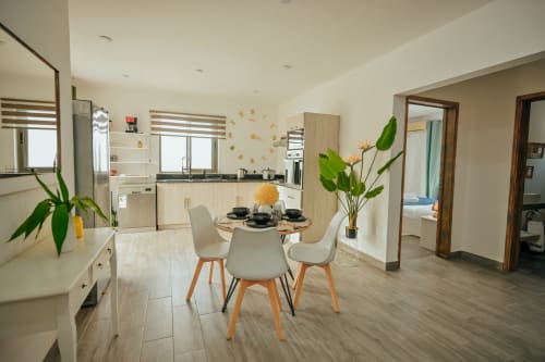 Modern kitchen and dining area in Summer of Hope villa at Gerards & Angel, Pereybere with dining table, plants, and pool view