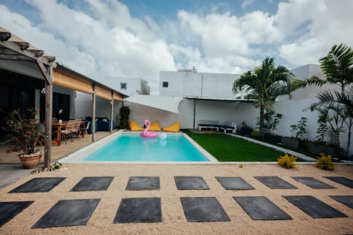 Gerards & Angel villa pool in Pereybere with turquoise water, pink flamingo float, tropical plants, and modern white