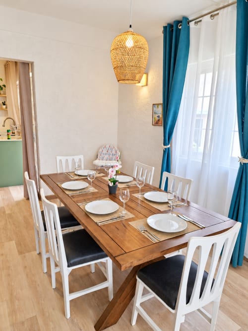 Elegant dining area at Gerards & Angel Ti Palmier apartment in Flic-en-Flac with wooden table, white chairs, and woven