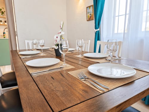 Elegant dining table set for guests at Gerards & Angel, Flic-en-Flac, with place settings and wine glasses