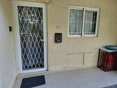 Apartment entrance at Gerards & Angel, Flic en Flac with secured door, mailbox, and windows on patio