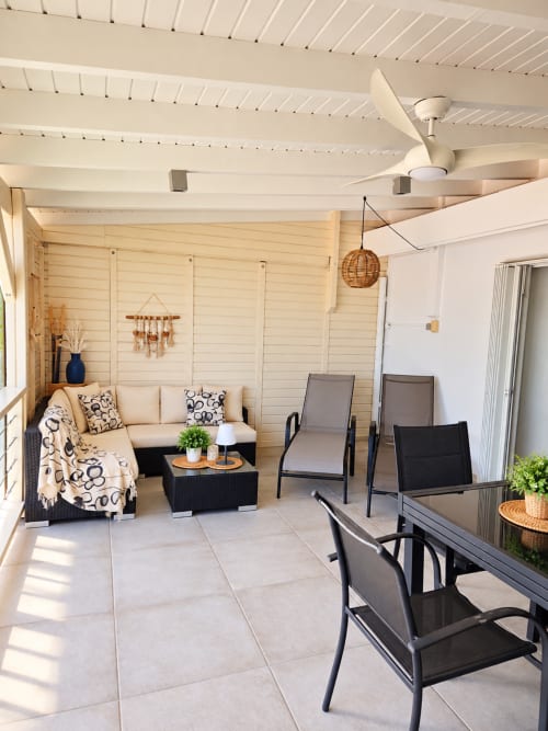 Modern bungalow terrace at Les Balcons D'oyster Pond with lounge seating, dining area, and sea view in Saint-Martin