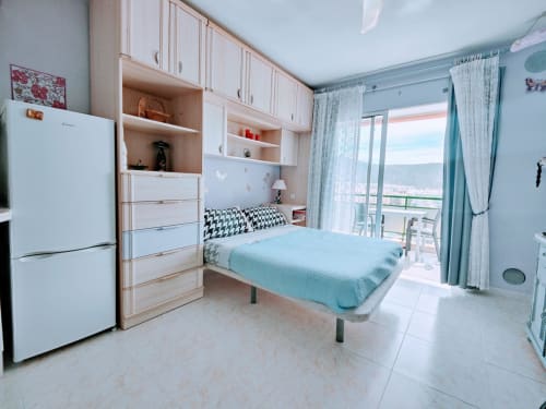 Colette Studio beachfront apartment in Los Cristianos with sea view, modern kitchenette, bed, and balcony