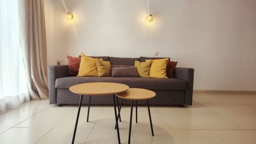 Modern living room at Manage Home Tenerife with gray sofa, yellow pillows, wooden tables in Playa de las Américas