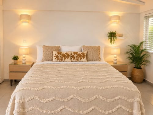 Serene bedroom at Les Balcons D'Oyster Pond, Saint-Martin, with beige bedding, wooden nightstands, warm lighting, potted