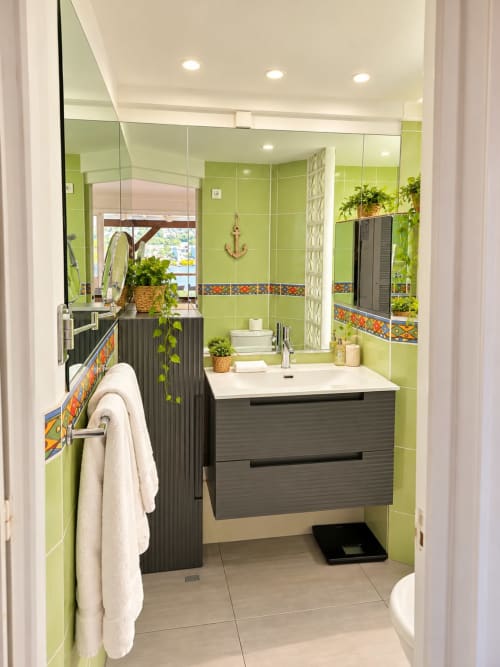 Modern bathroom in Bungalow 5 at Les Balcons D'oyster Pond, Saint-Martin, featuring lime green tiles, dark vanity, and sea