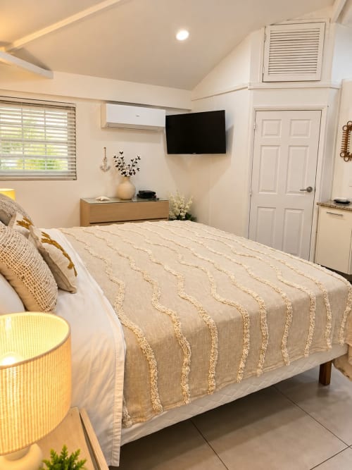Bright bungalow bedroom at Les Balcons D'oyster Pond, Saint-Martin with queen bed, flat-screen TV, and ocean views