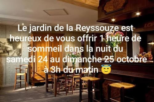 Le Jardin de la Reyssouze restaurant interior with wooden chairs and tables in Gorrevod