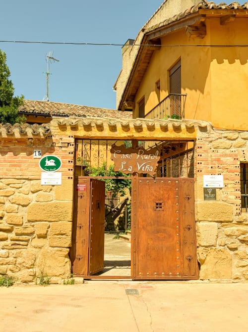 Casa Rural La Viña entrance in Cuzcurrita de Río Tirón with traditional wooden doors and stone facade