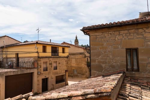 Rustic stone buildings with terracotta roofs at Casas Rurales La Viña in Cuzcurrita de Río Tirón, Spain