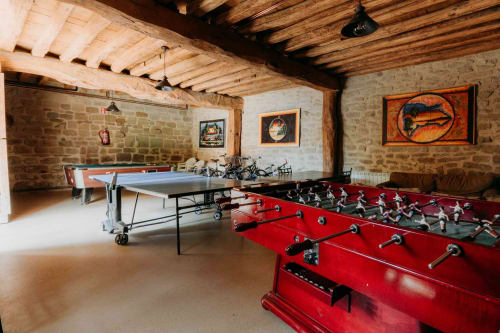 Games room at Casas Rurales La Viña with foosball table, ping pong table, and stone walls