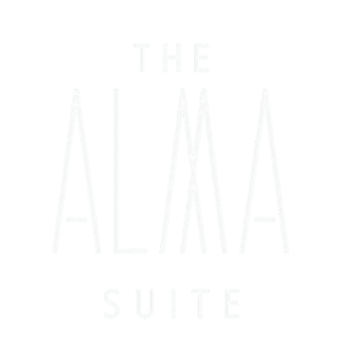 The Alma Suite hotel entrance in Álora, Spain with elegant white architecture and arched doorway