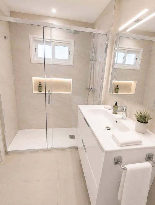 Modern luxury bathroom with walk-in shower, double sink vanity, and sea views at Manage Home Tenerife Costa Adeje apartment