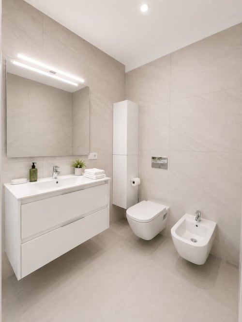 Modern bathroom in Manage Home Tenerife apartment, Costa Adeje with white vanity, toilet, bidet and tile fixtures