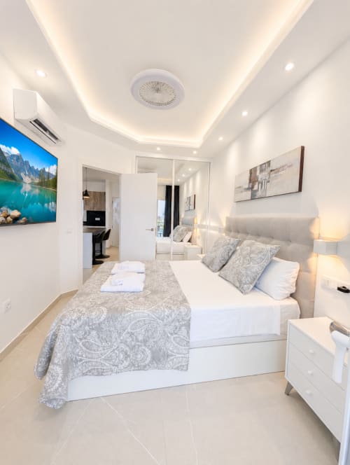 Luxury bedroom at Manage Home Tenerife in Costa Adeje with sea view, modern furnishings and smart ceiling fan