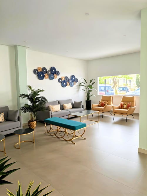 Modern apartment lobby at Manage Home Tenerife in Costa Adeje with grey sofa, gold chairs, turquoise bench, and decorative