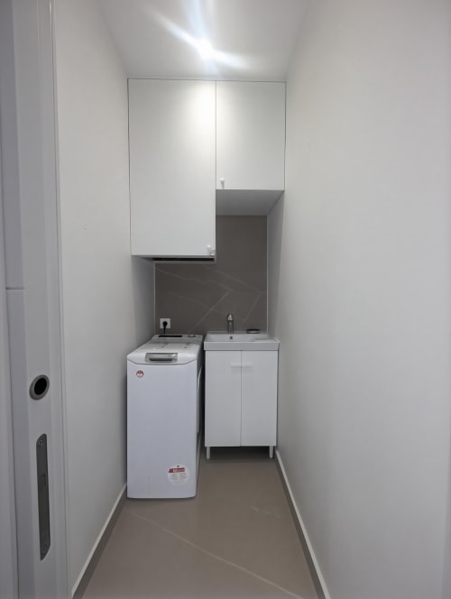 Modern laundry room with washing machine and sink cabinet in Manage Home Tenerife apartment, Costa Adeje
