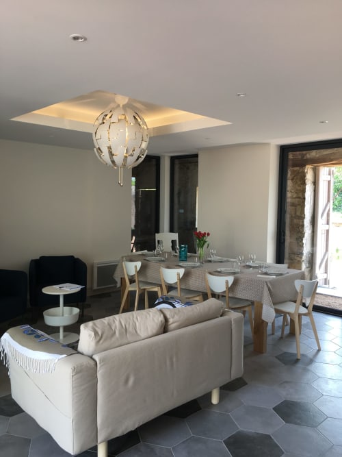 Modern dining and lounge area in À tout Coeur cottage at Les Charmises, Charroux with elegant lighting and garden views