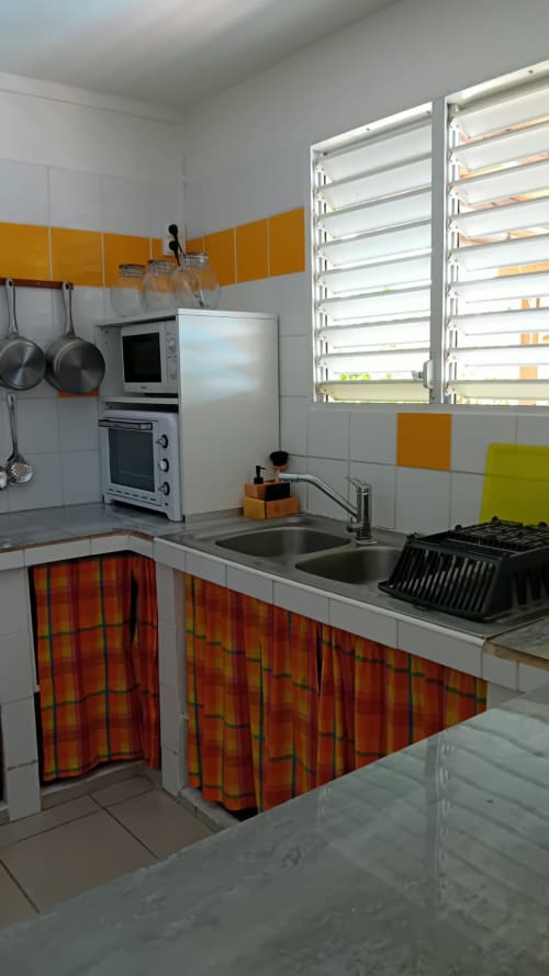 Cuisine moderne à Villa Ti Soley Mafanga, Bouillante avec appareils en acier inoxydable et accents colorés