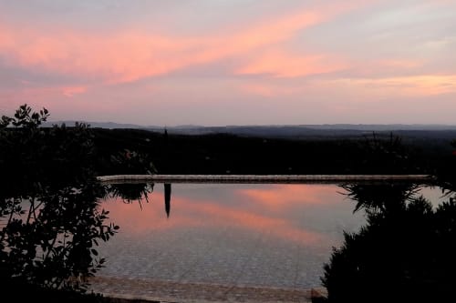 Pôr do sol sobre águas tranquilas e zonas húmidas do hotel rural SELÃO DA EIRA no Alentejo, Portugal