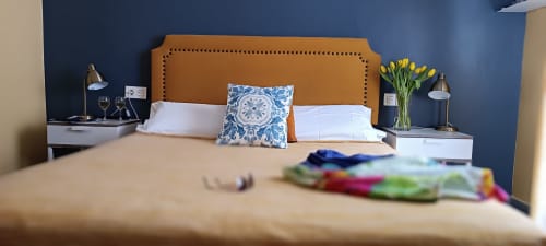 Élégante chambre double à la Pensión Alicante San Nicolás avec tête de lit caramel, mur d'accent bleu et oreillers blancs