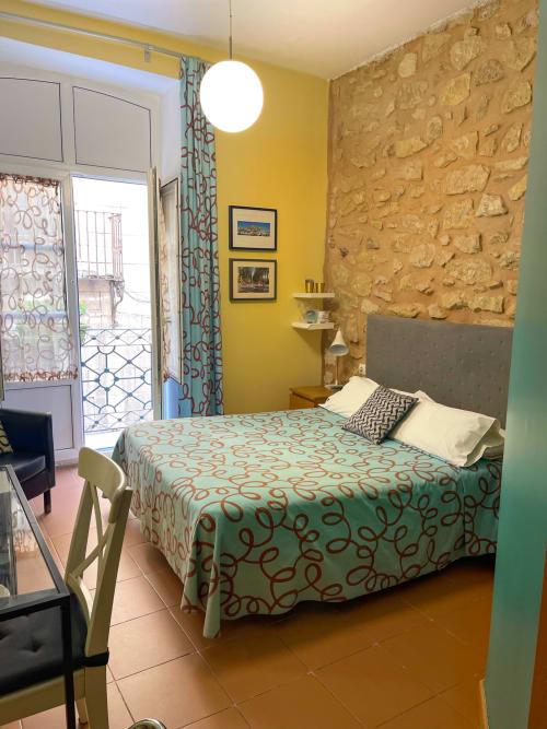Luminosa camera doppia presso Pensión Alicante San Nicolás con pareti gialle, accenti in pietra, accesso al balcone e vista sulla città