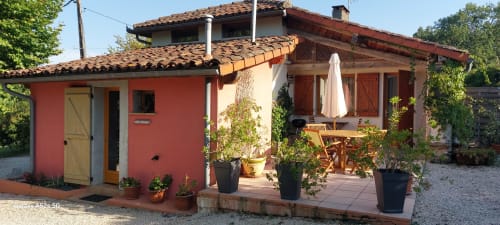 Sunflowers cottage at Les Gites de Campardon in Monties, France, featuring red and cream exterior with terracotta roof,