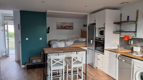 Studio apartment kitchen and dining area with bed loft in Finistère Sud, France