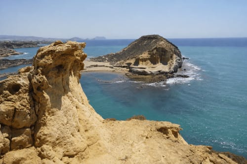 Dramatic coastal cliffs and turquoise Mediterranean waters near Cuevas del Almanzora, Spain