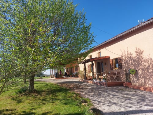 Orchids cottage at Les Gites de Campardon with terrace, garden seating, and tree-shaded grounds in Monties, France