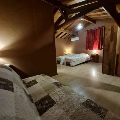 Familiekamer van Gîte Cristal met aparte bedden en slaapbank.