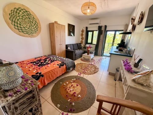 Studio Le Chissioua à Sada avec vue sur mer, lit décoré, coin séjour et terrasse privée