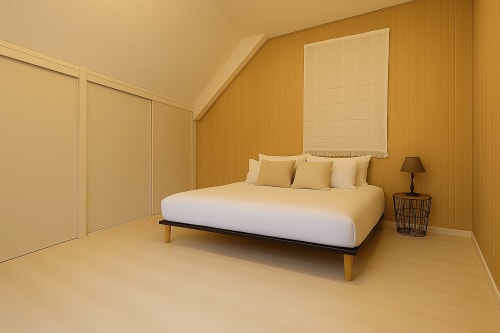 Chambre moderne de l'appartement Saint-Valery-en-Caux avec murs en bois, lit aux coussins et vue sur la ville