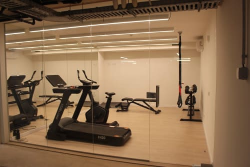 Modern gym at Break Lovers with cardio equipment and weights overlooking Tavira, Portugal