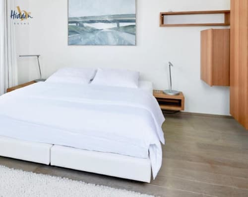 Modern Superior Room at Hidden Bay Hotel with white bedding, hardwood floors, and city view artwork