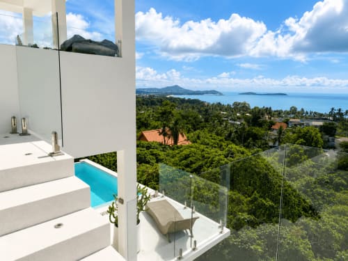 Luxury villa bathroom with sea view in Ko Samui overlooking turquoise pool and tropical island landscape