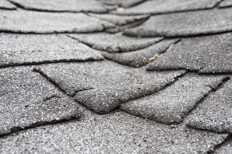 Warped shingles indicate the need for new roofing.