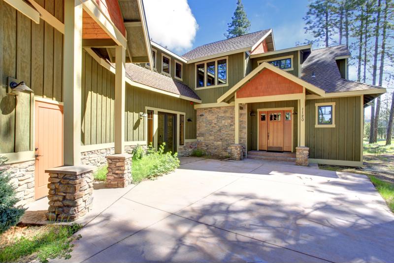 Exterior of house with siding and stone accent wall.