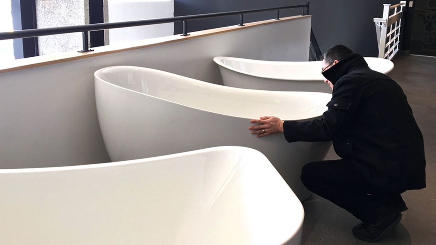 A man analyzing a freestanding bathtub