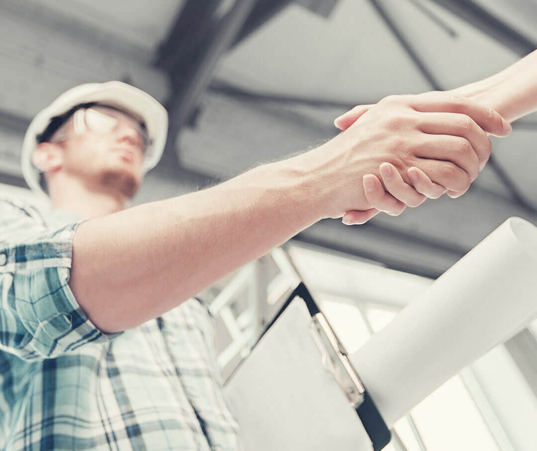 A man representing an Architect shaking hands with someone.