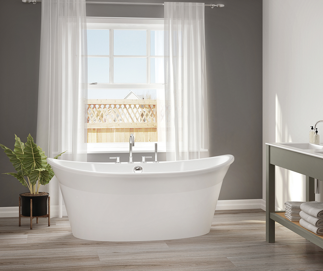 A beautiful white freestanding tub next to open window with sun light beaming through.