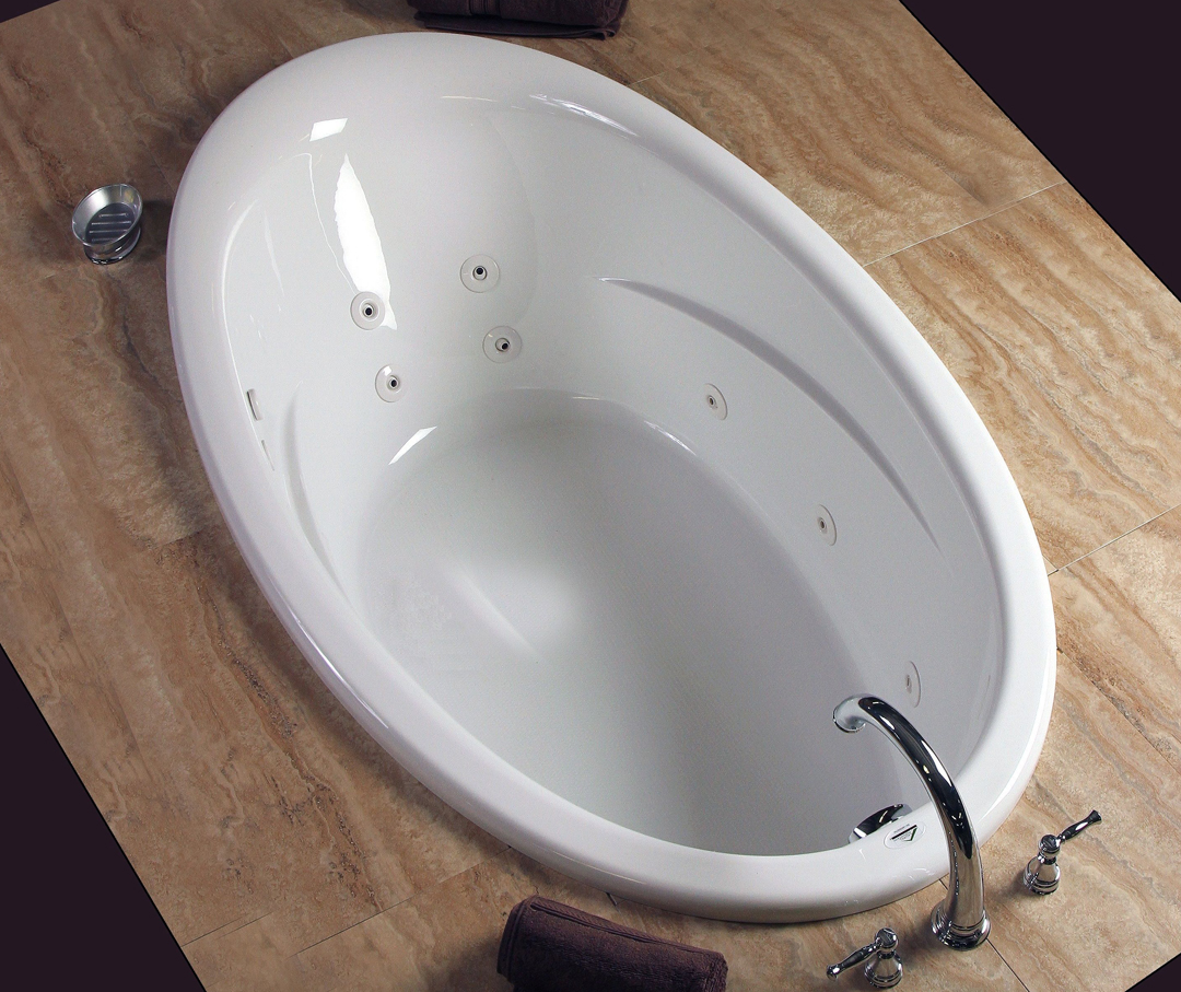 Image of a chrome bathtub faucet along with a jetted system oval bathtub.