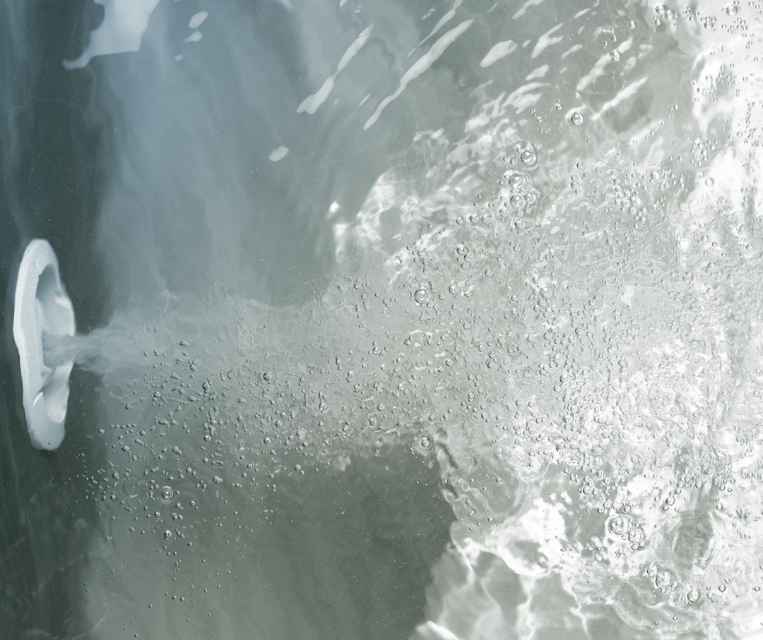 An image of a jet system pushing water inside of a deep soaker tub.