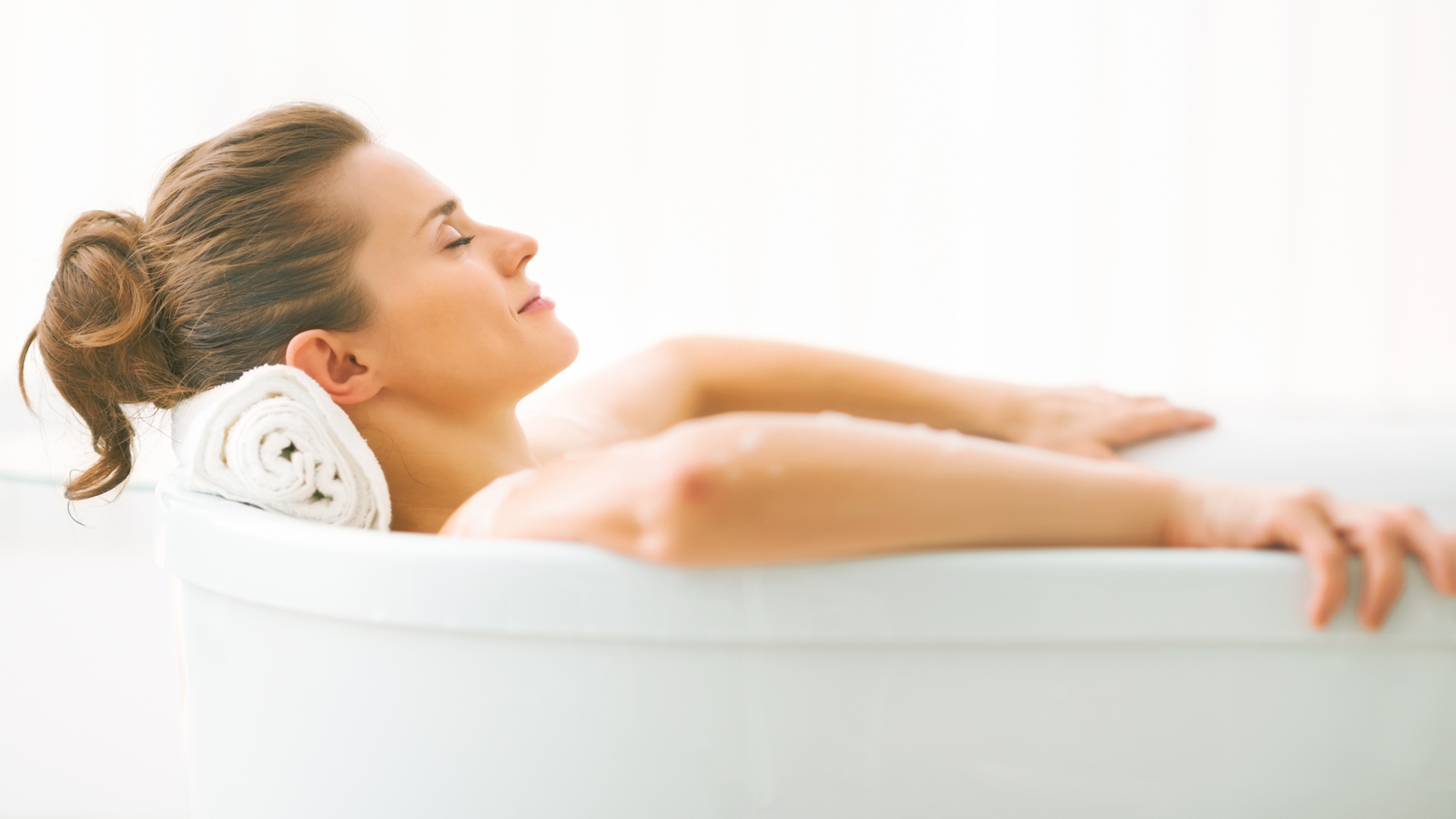 Image of a woman relaxing in a therapy tub.