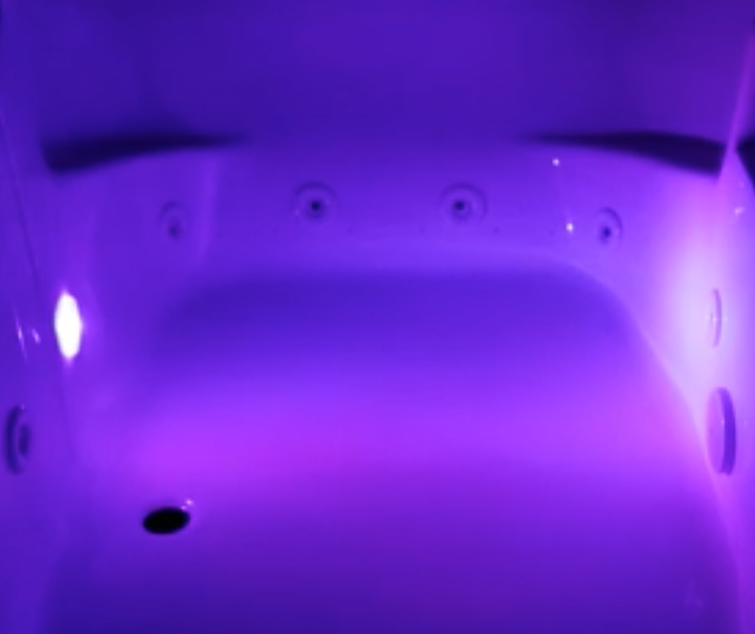 Image of a jetted tub with violet color therapy.