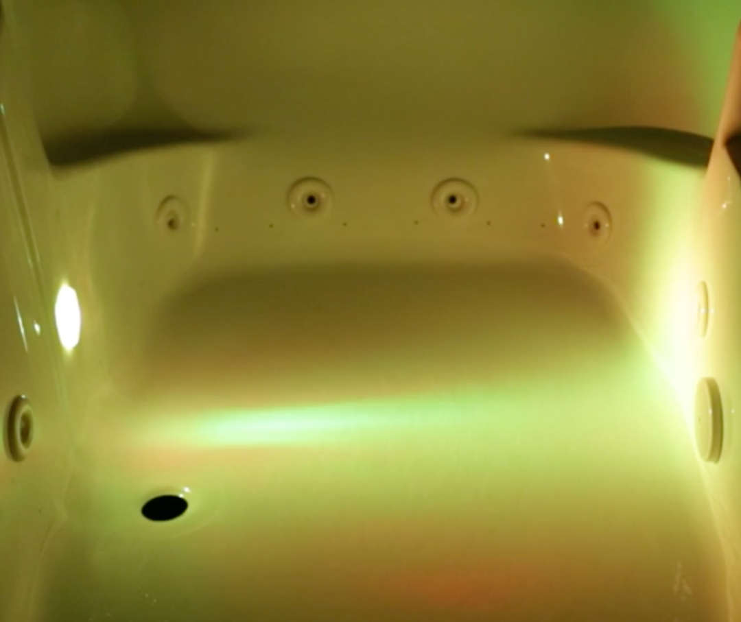 Image of a jetted bathtub with color therapy yellow.